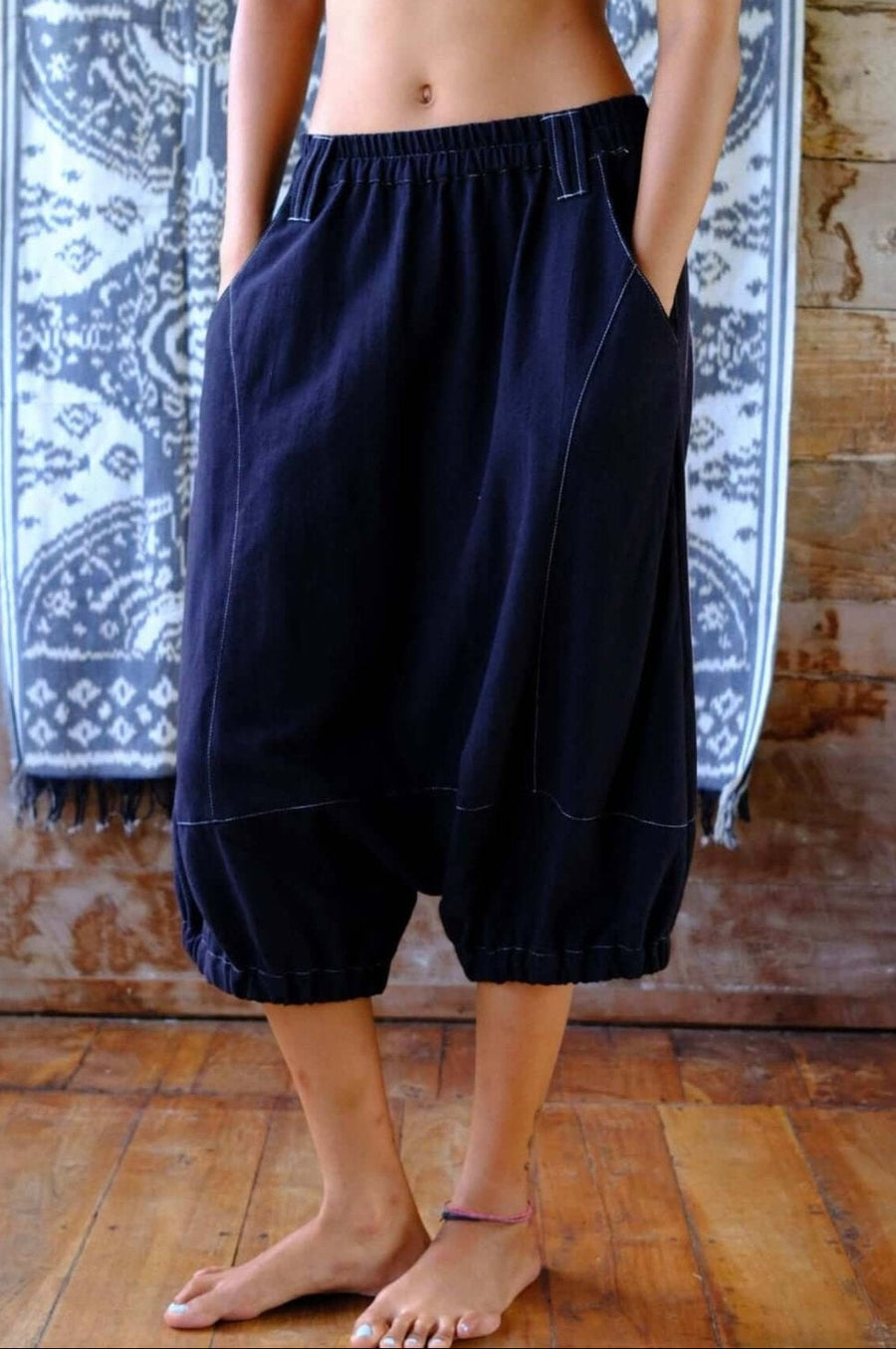 Low-crotch cotton pants worn by a model, showcasing breathable summer wear in black.