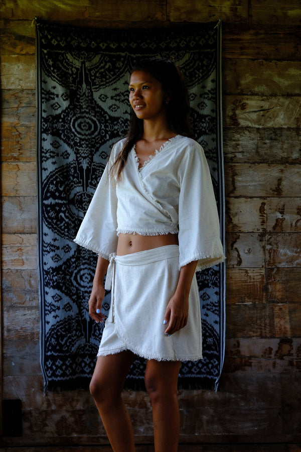 White robe over handwoven rug, slow-made cotton
