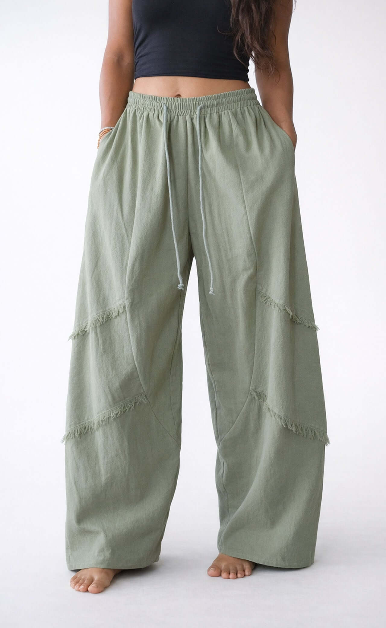 Front view of woman wearing matcha color cotton handmade pants from snug brandwear bali collection