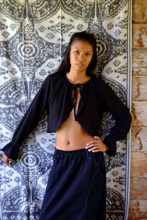 Model showcasing the Night Semi Crop Cape paired with a black skirt, emphasizing bali inspired fashion.