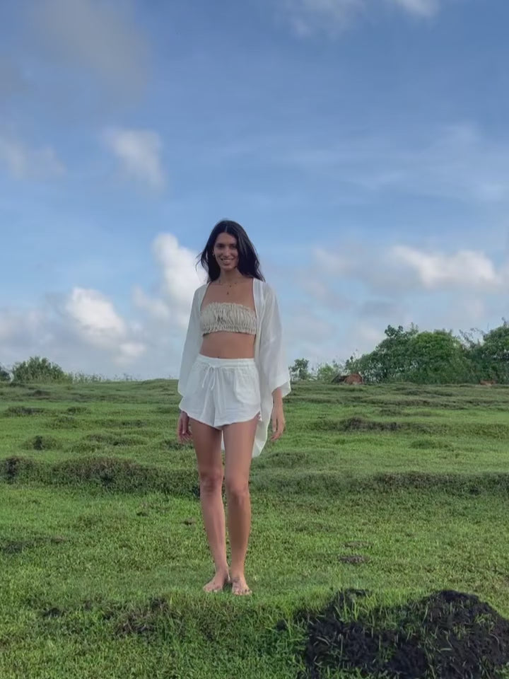 Model wearing Noa Woman Kimono with a flowy design in a natural outdoor setting, perfect for summer style.