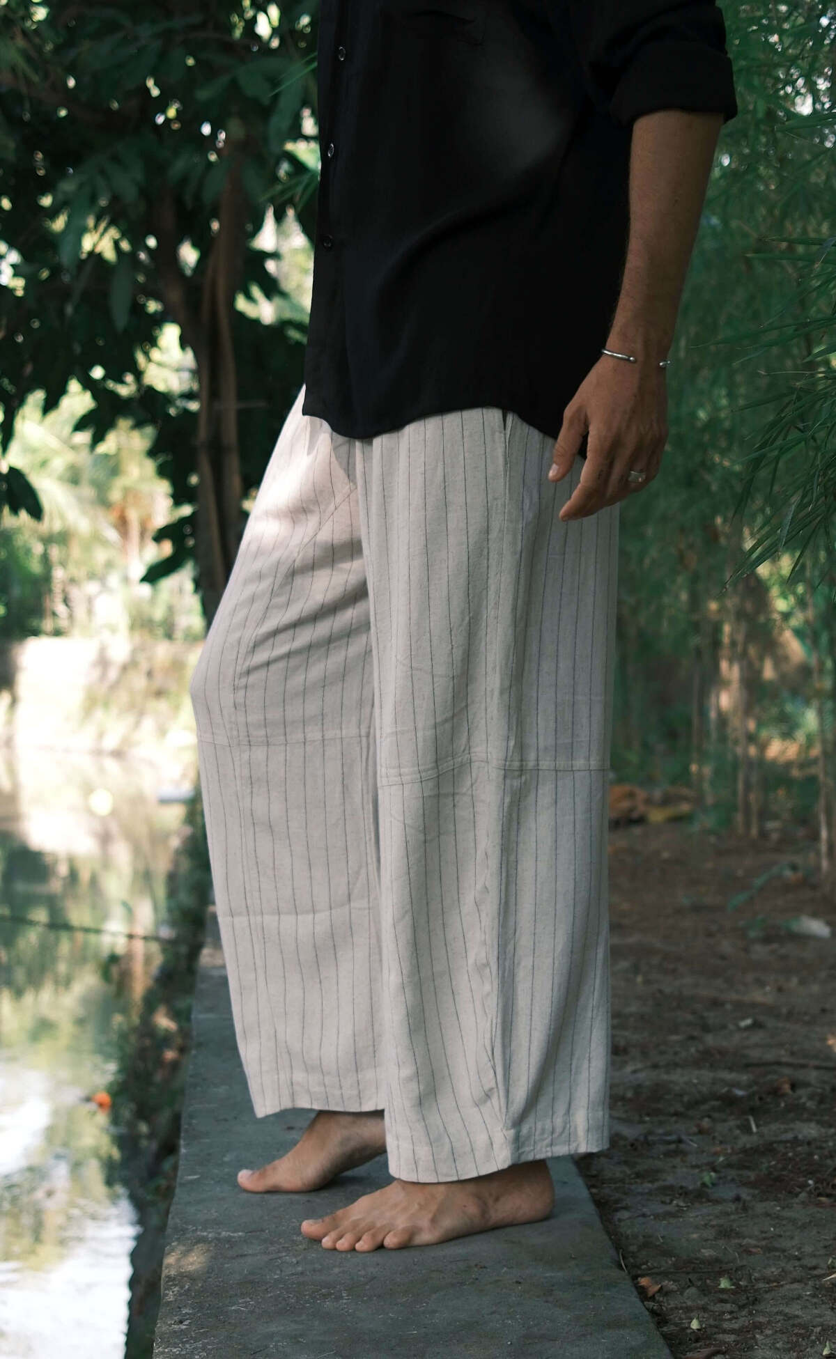 Sandline Pants - Man showcasing stylish beige stripe pants perfect for loungewear and tropical weather.